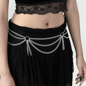 Detail of silver gothic cross tassel body chain with triple layered metal links on waist