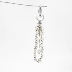Detail of multi-layer bag chain with heart charm, faux pearls and silver metal beads