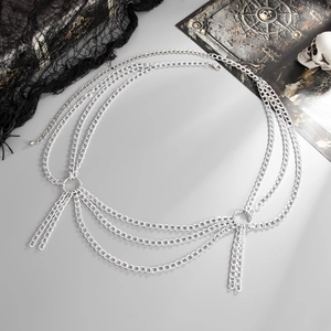 Close-up of silver layered waist chain with cross charms and fringe on grey background
