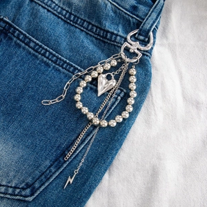 Silver multi-layer trousers chain with heart and lightning pendants on denim pocket