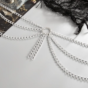 Macro shot of silver gothic body chain with multilayered tassels and central ring detail