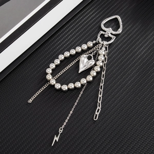 Silver multi-layer keychain with heart bead loop and lightning charms on black fiber