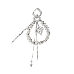 Detailed view of silver heart clasp, metallic beads, and lightning pendant key chain