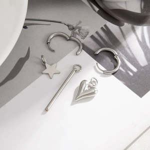 Close-up of silver CCB beaded heart and star charms with metal chain tassel earrings