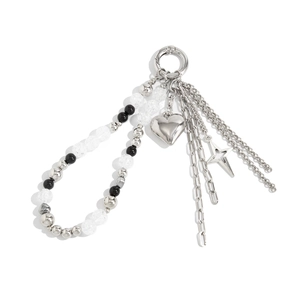 Detailed view of heart and star pendants on a stylish faux pearl and metal bead chain charm