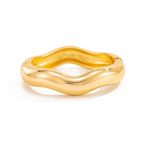 Macro detail of high-polish gold wave bangle with visible hinge and smooth curved surface
