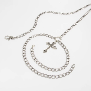 Detailed macro view of gothic silver metal cross pendant with vintage relief patterns