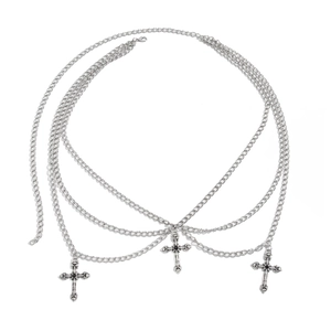 Macro detail of silver layered waist chain featuring gothic cross pendants and relief patterns
