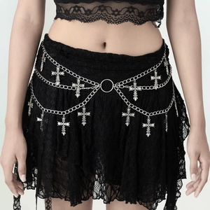 Detail of gothic silver metal body chain with triple layers and cross pendants