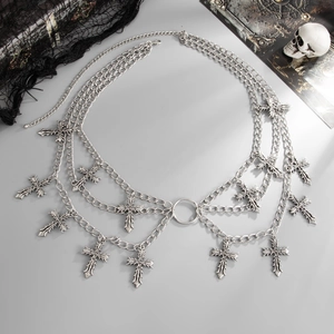 Macro view of gothic silver layered waist chain with multiple cross pendants