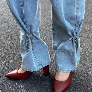 Silver layered chain tassels on metal safety pins for denim trousers styling detail