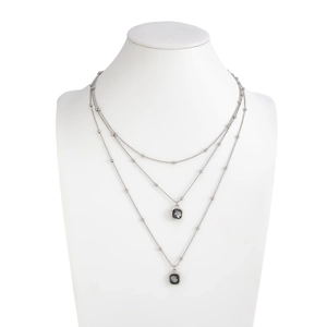 Detail view of triple-layered silver bead chain necklace with dark square pendants