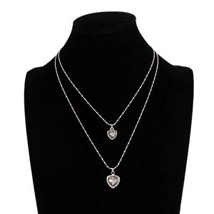 Close-up of double-layer beaded silver chain with gray acrylic heart pendants on neck model