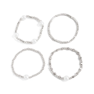 Detail of four-piece silver beaded jewelry set with baroque pearls and diamond heart charm