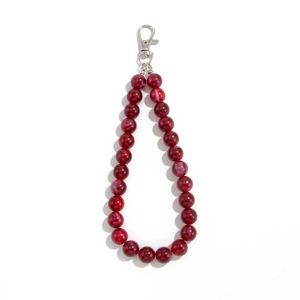 Detail of red and white marble acrylic beads with a silver metal lobster clasp keychain