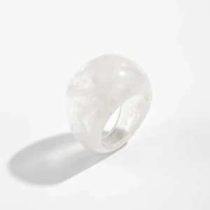Macro view of minimalist white resin ring with icy marble texture and smooth finish