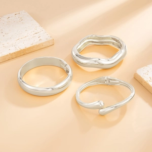 Three-piece silver cuff bracelet set with smooth, wavy, and open geometric designs