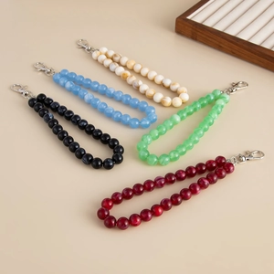 Detailed view of colorful acrylic beaded bag chains with marble patterns and silver clasps