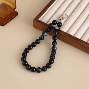 Detail of blue marble acrylic beads on ring strap with silver metal lobster clasp