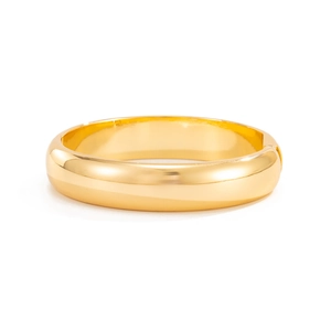 Detailed close-up of a wide golden cuff bracelet featuring a polished finish and side hinge