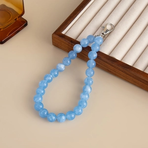 Close-up of light blue marble texture acrylic beads with a silver metal lobster clasp