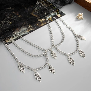 Detail view of silver punk body chain with multilayered spider web diamond pendants