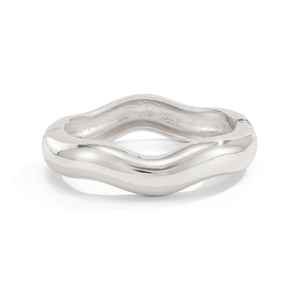 Close-up of a silver polished wave-shaped hinge bracelet with a sleek minimalist finish