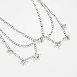 Detailed view of punk spider web multilayer body chain with gothic bat charms