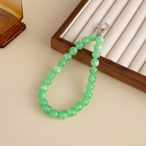Close-up of green marble acrylic beaded chain with silver metal lobster clasp