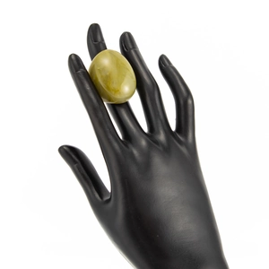 Close-up of translucent amber resin ring featuring marble texture on a black hand model