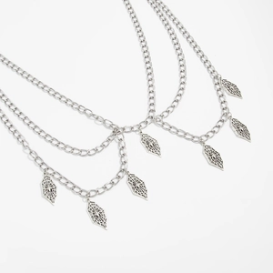 Detailed view of silver layered body chain with intricate spider web diamond pendants