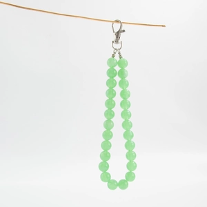 Close-up of light green acrylic beaded bag chain with silver metal lobster clasp