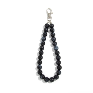 Detail of handmade black marble texture acrylic beads and silver lobster clasp