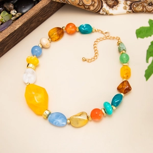Detail of colorful resin beaded necklace with gold lobster clasp and extension chain