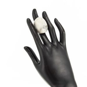 Detail of marble pattern resin ring showing white stone texture on black model hand