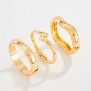 Three-piece gold polished set with minimalist teardrop and wave geometric open bangles