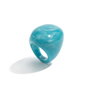 Detail of teal blue resin ring with white marble texture and transparent finish