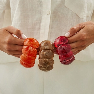 Three-piece chunky resin bangles with marble texture in orange, brown, and burgundy colors