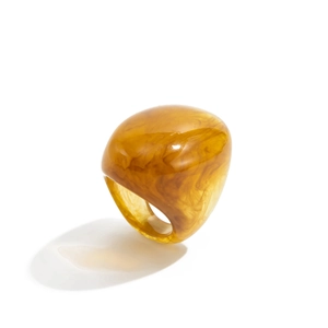 Macro detail of amber resin ring with marble swirl pattern and thick rounded profile