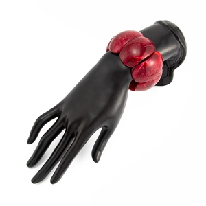 Detail of red marble texture resin stretch bracelet on a black display hand