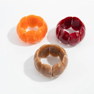 Retro amber resin cuff bracelet with marbled texture in orange, red and coffee brown