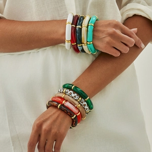 Close-up of stacked resin bamboo bracelets with leopard print and marble patterns