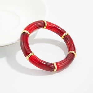 Detailed shot of red marble acrylic bamboo bracelet with gold metal spacer rings