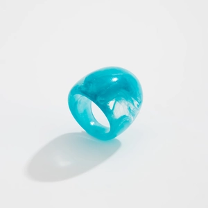 Macro detail of transparent blue marble resin ring with unique ocean texture