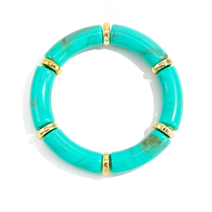 Close-up of turquoise resin curved tube bracelet with polished gold metal spacers