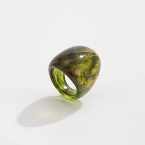 Detailed view of the translucent resin ring with green and amber marble textures