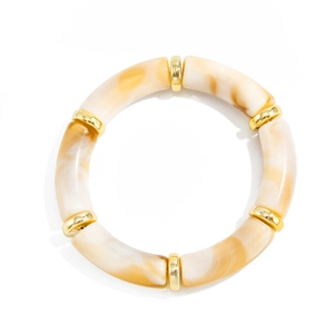 Detailed top view of a resin tube bracelet with cream marble patterns and gold metal accents