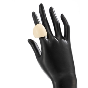 Detailed close-up of a cream resin dome ring displayed on a black hand mannequin model