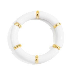 Detail of white acrylic tube bracelet with polished gold-tone metal spacers on white background