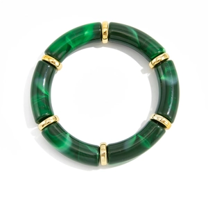 Detail of green marble resin tube bracelet with decorative gold metal spacer beads